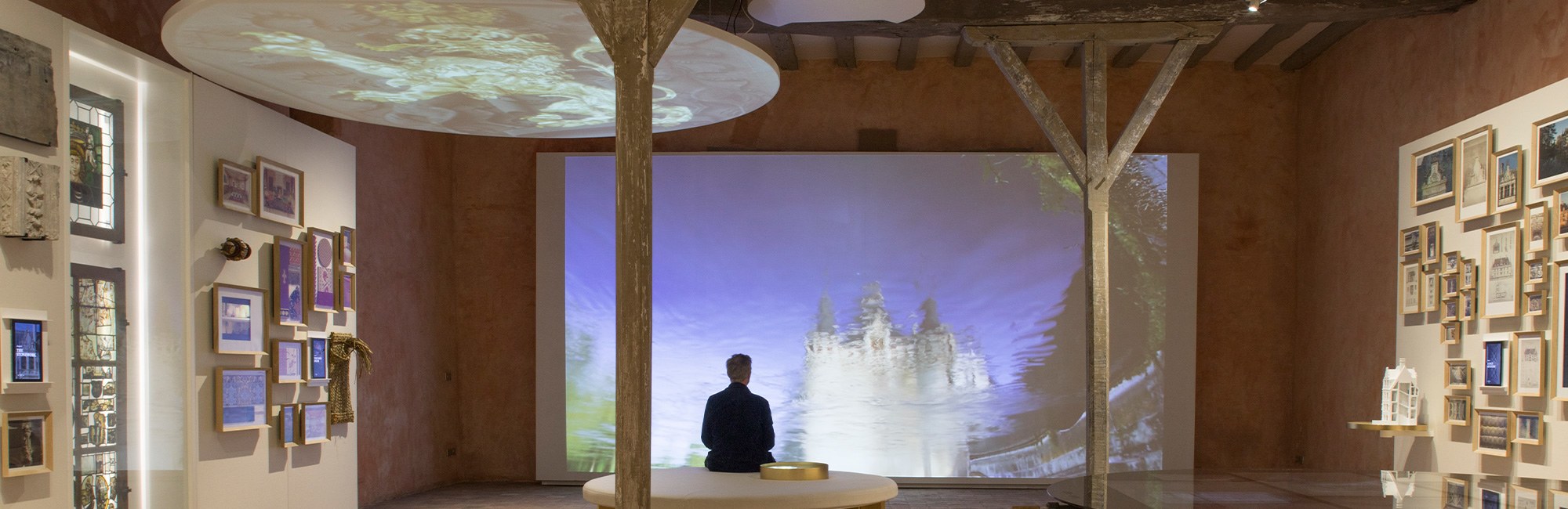 Muséographie : bancs sobres en bois et toile, signalétique projetée